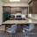 a kitchen with a bar and chairs